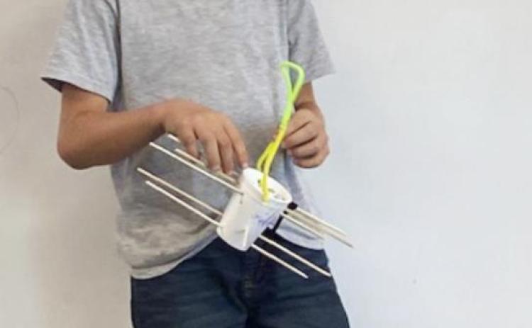 Second graders build bird feeders