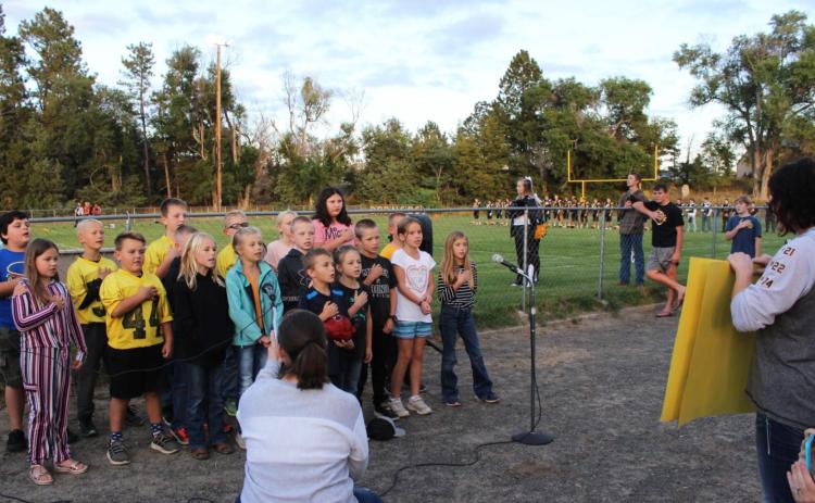 2nd-3rd grades sing national anthem at football game