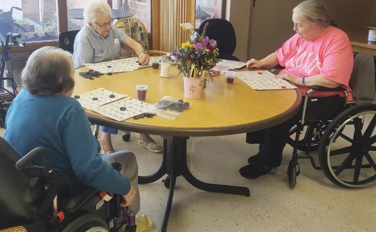 L-r: Peggy Barnt, Nadene Andersen and Ann Connell playing Bingo.