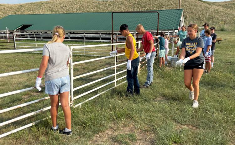 Hooker County 4-H members cleaned out the hog barn, picked up trash around the fairgrounds and painted the show ring last Tuesday, July 21 to prepare for fair this week. Gerri Peterson