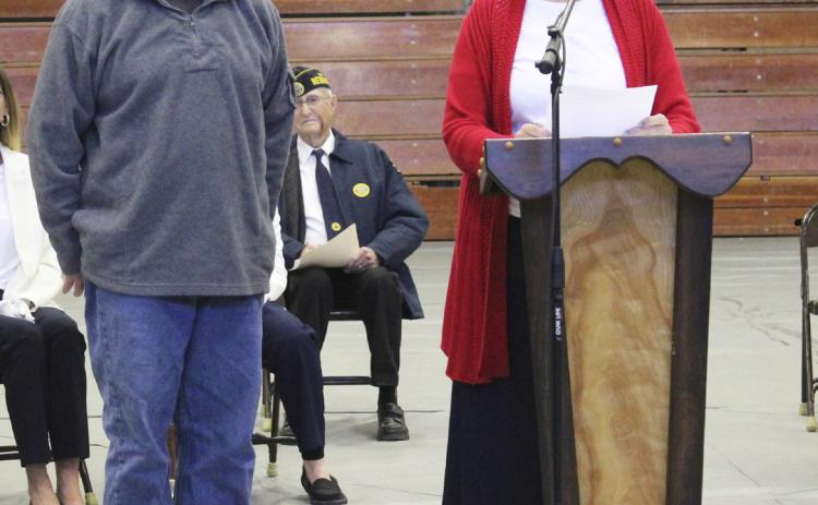 American Legion Auxiliary president Eva Crawford recognizes Chris Jensen during the Veterans Day program.