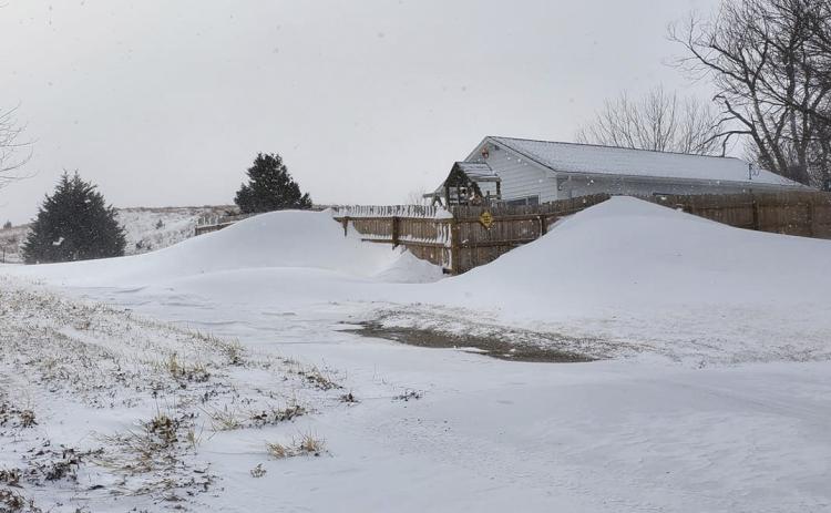 Drifts up against a 6 foot tall fence at Jim and Crystal Hessin’s in Mullen.