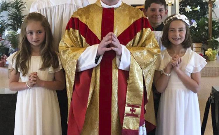 Lillian Ericksen, daughter of Marc and Alicia Ericksen, and Avery Vinton, daughter of Kevin and Callie Vinton, celebrated their First Communion during Mass at St Mary’s, Mullen, on April 16 with Father Matthew Nash presiding. A noon luncheon followed the celebration for the parishioners and guests in honor of the communicants. Pictured front l-r: Avery Vinton, Father Matthew Nash, Lillian Ericksen. Back: Altar servers Cian and Colin Connealy. Marc Ericksen