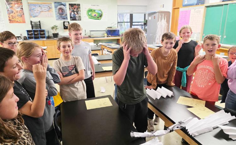 STEM Club met last Tuesday, Oct. 14 to think like engineers and worked on designing the strongest bridge. There were lots of great designs! Pictured is Caleb Deibler reacting as his design was tested. courtesy photo