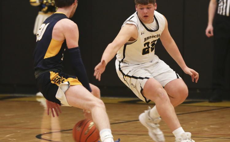 Deacon DeNaeyer on defense against Paxton in the subdistrict final game on Feb. 23. Megan Andersen