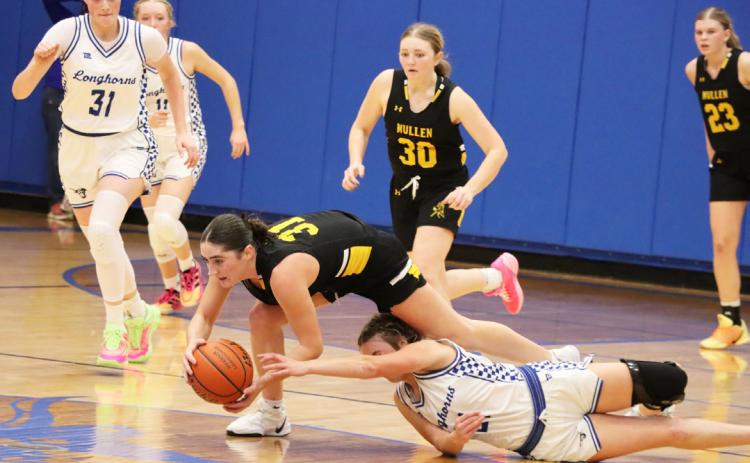 Jenna Donohoe holds onto the ball as she trips over a Hyannis defender last Thursday. Sue Licking