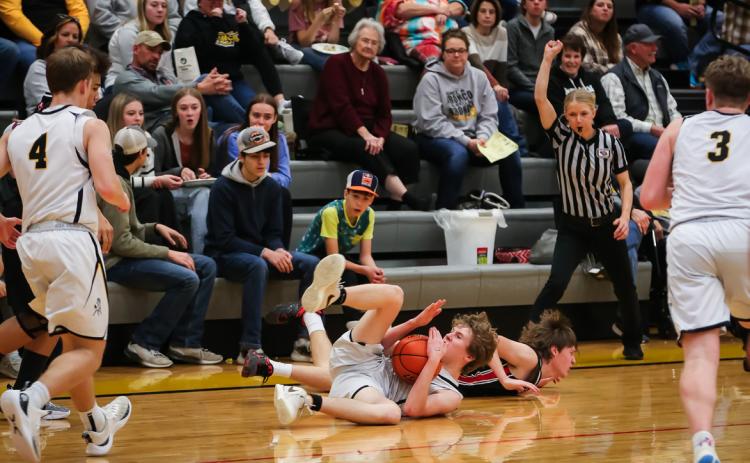 Brandon Hardin motions for a time out from the floor against Sandhills Valley on Feb. 8.