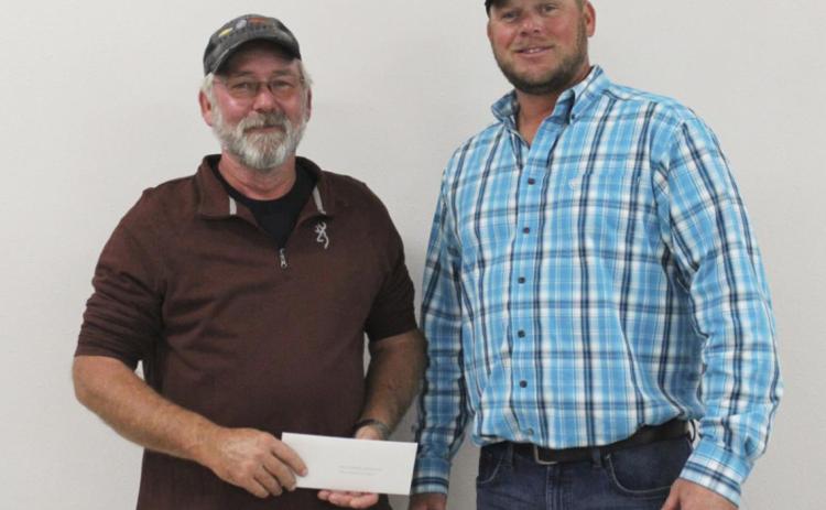 Tim Andersen (right) presents Darrell O’Neal with the Megan Andersen Photography family photography package.