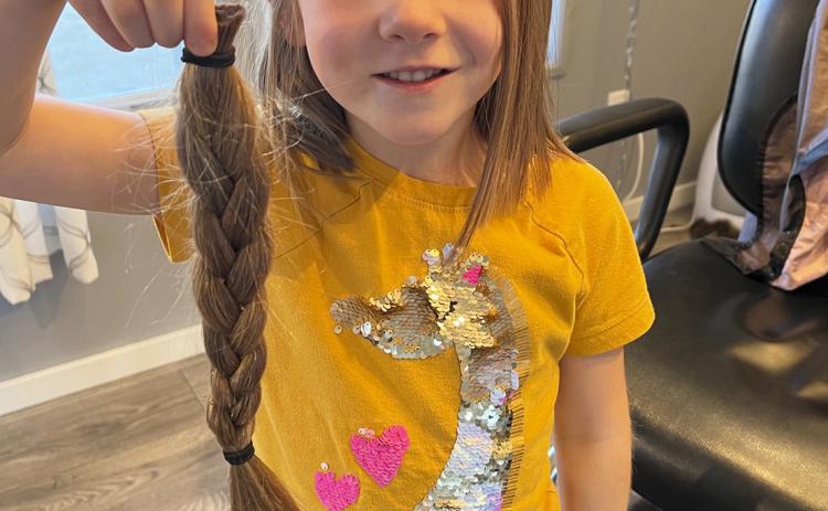 Eve Ericksen decided that since her big sister did it, she wasn’t scared to “give a wig.” Eve, a kindergartner at Mullen Elementary, donated 14 inches to Wigs for Kids. Marc Ericksen