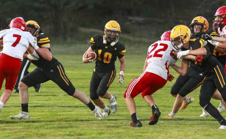 Cody Walker follows his blockers up the field last Friday night against Sutherland. Carolee Brown Photography