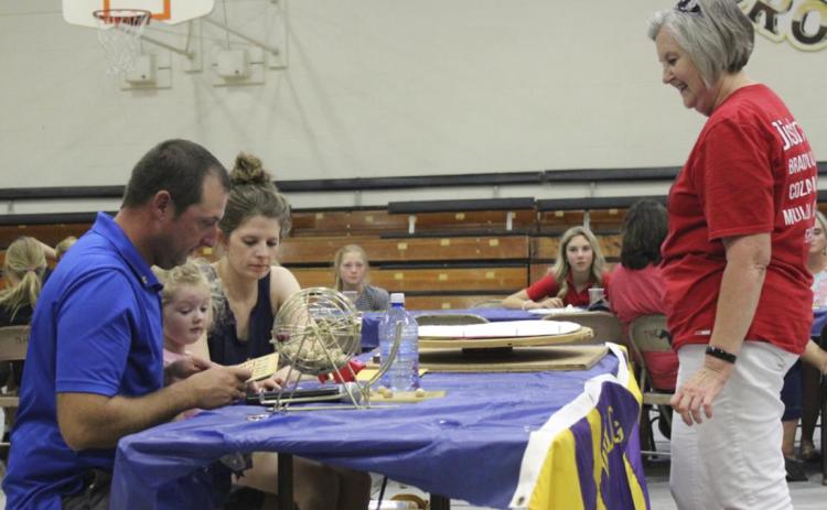 Lions Club members Ryan, Shelby and their daughter Anna Ridenour verify Diana Brost’s Bingo last Thursday evening. Gerri Peterson