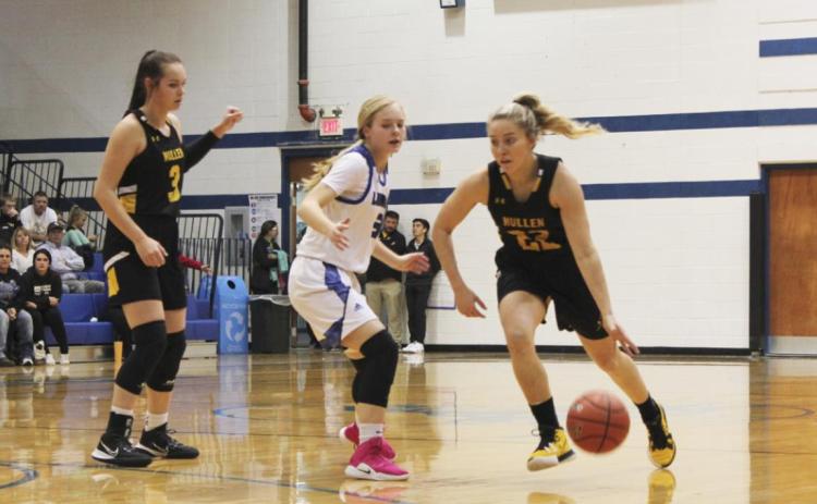 Taylor Svoboda dribbles around a defender at Hyannis while Shelby Welsh prepares to set a screen. Alex Moore
