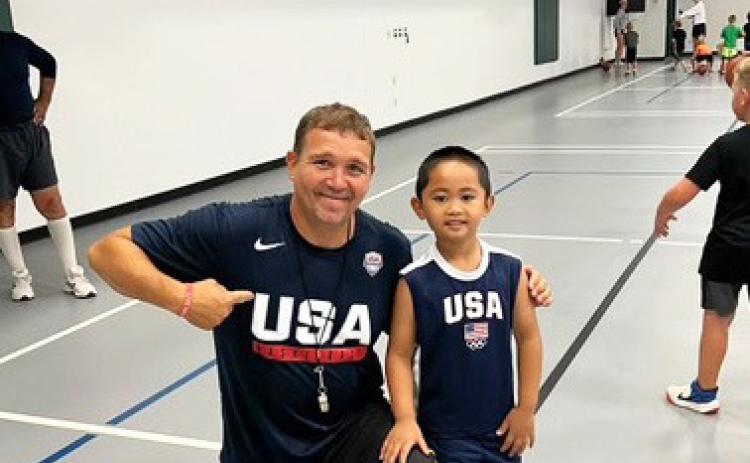 Jeff Nichols and a young kiddo sport their team USA jerseys at basketball camp. courtesy photo