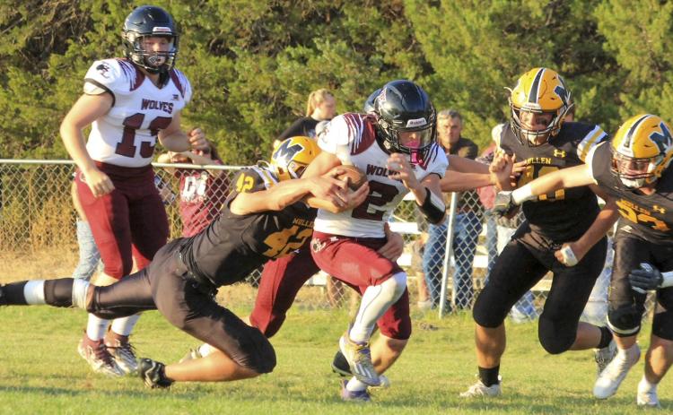 Tate Kvanvig pulls down Twin Loup’s quarterback last Friday night with James Kessler and Ethan Hardin on their way to assist. Carolee Brown
