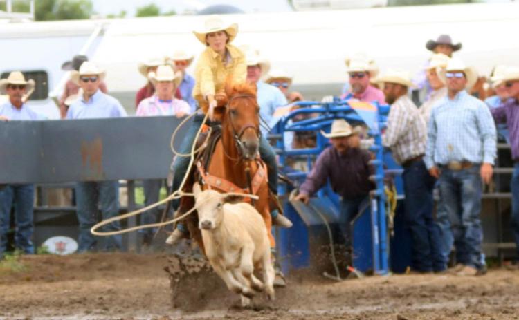 Stephanie Miller Whitney Jennings competing in the breakaway at Lexington with her dad, Royce Jennings, watching from the chute.