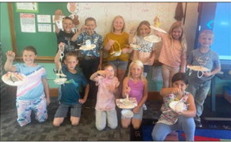 Second graders build bird feeders
