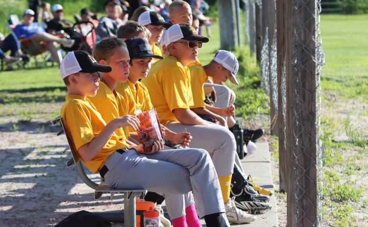 Gerri Peterson With sunflower seeds in hand, the baseball team bench watches the action Monday evening as they won their tournament game 11-3 against Arnold. The Broncos will play Stapleton in the championship game this Thursday, June 26, in Mullen. The consolation game will begin at 4:30 p.m., with Mullen’s game to follow about 6:00-6:30 p.m. Concessions will be available.