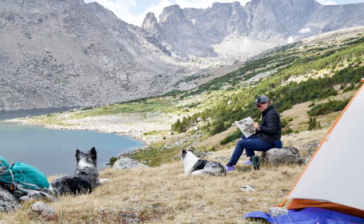 First newspaper to be read at Tayo Lake? We’re not sure, but it’s for sure the first time a copy of the Hooker County Tribune’s Vacationer Issue has been there! Photo by Colby Osborn of his wife Amanda and their dogs Dakota and Mica soaking in the views of the Wind River Range in Wyoming.