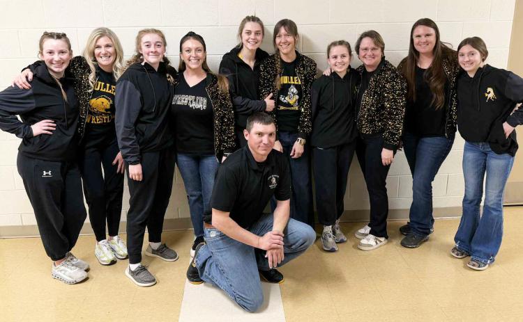 The Mullen High School girl wrestling moms showed up with some extra sparkle at District wrestling February 6-7. Moms and their daughters are pictured with Coach Zack Cox - who definitely needs his own sparkle now! Pictured l-r: Hope and Tami Miller, Kassidy and Joni Cheever, Georgia Wingebach and Rebecca Garrett, Audrabell and Robyn Werth, team mom Erin Cox with student manager Olivia Cox. courtesy photo