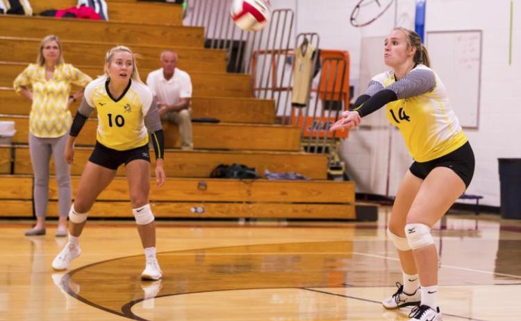 Jadyn Andersen passes up the ball at Valentine last Thursday, while teammate Taylor Svoboda looks on. Megan Andersen