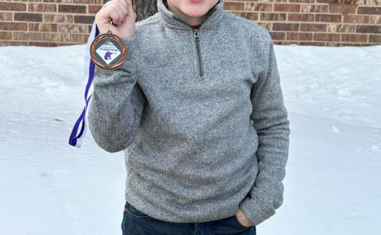 Zach Hicks with his medal at Harrison.