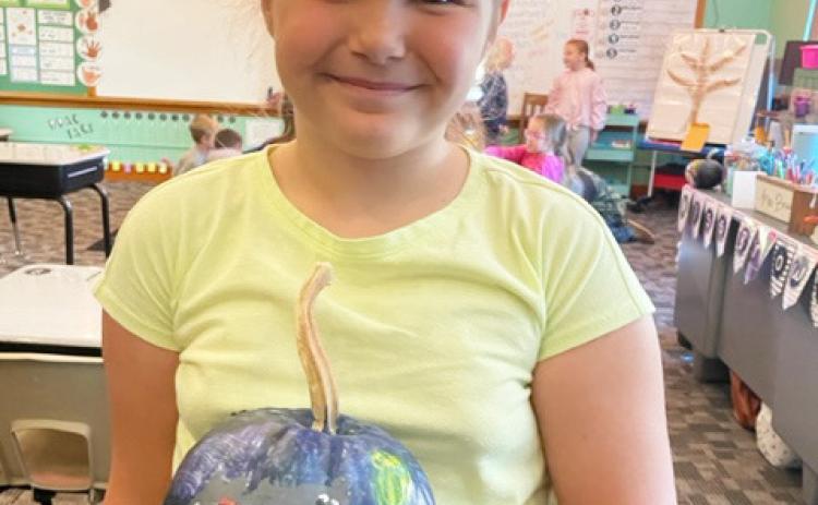 The 2nd grade students recently painted pumpkins. Pictured is Kaleah Heaton.