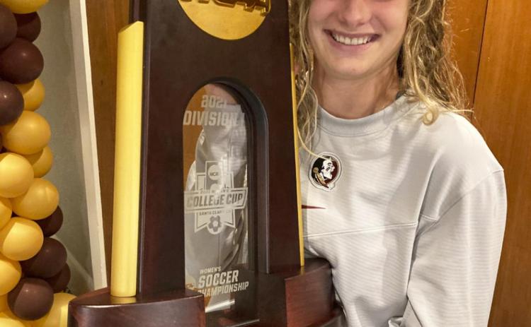 Jaelin Howell with her team’s NCAA National Champion trophy. courtesy photo