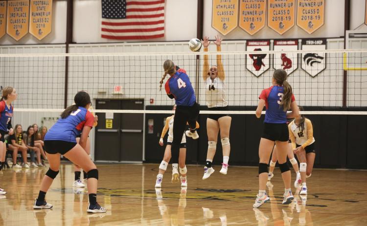 Senior Jadyn Andersen goes up for a block in the Broncos’ season opener against Medicine Valley. Megan Andersen