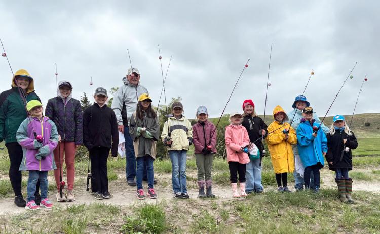 Fishing at Girl Scout Day Camp were, l-r: Maci Walz, Anna Hessin, Ava Walz, Ella Walz, Pastor Bill Williams, Mia Roman, Keira Kearns, Anna Ridenour, Tatum Deibler, Sadie Hoyt, Pastor Shanon Williams, Danielle Peterson, Daryl Deibler. Sooky Marks