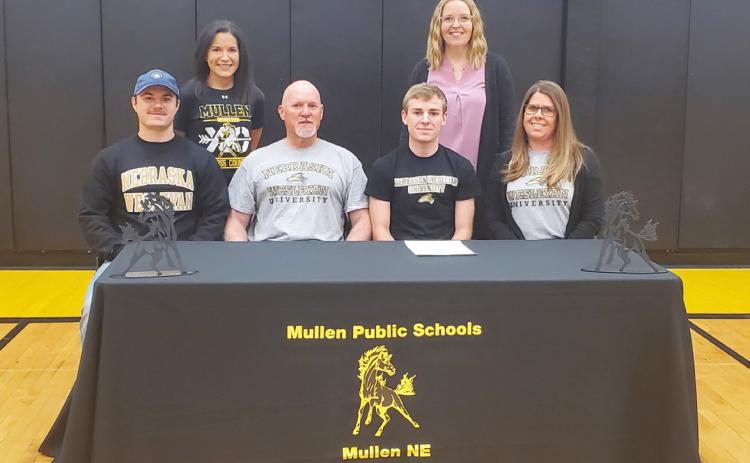 Mullen High School senior Kyle Finney signed his letter of intent to run cross country and track at Wesleyan University last Wednesday, March 6. Kyle is pictured with his parents, Scott Finney and Lori Finney, and brother Jared. Also pictured are MHS cross country coach Janie Kuncl (back left) and one of the MHS track coaches, Sarah Hardin. Mike Kvanvig