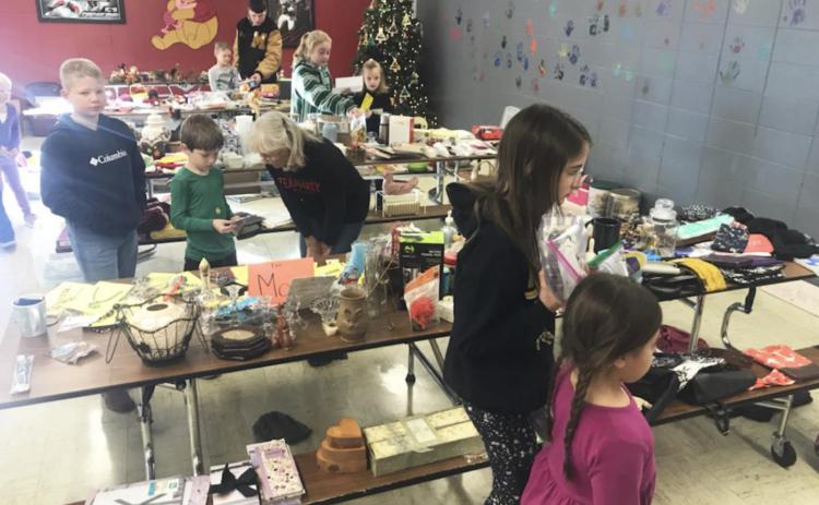 Elementary students purchase gifts for family members