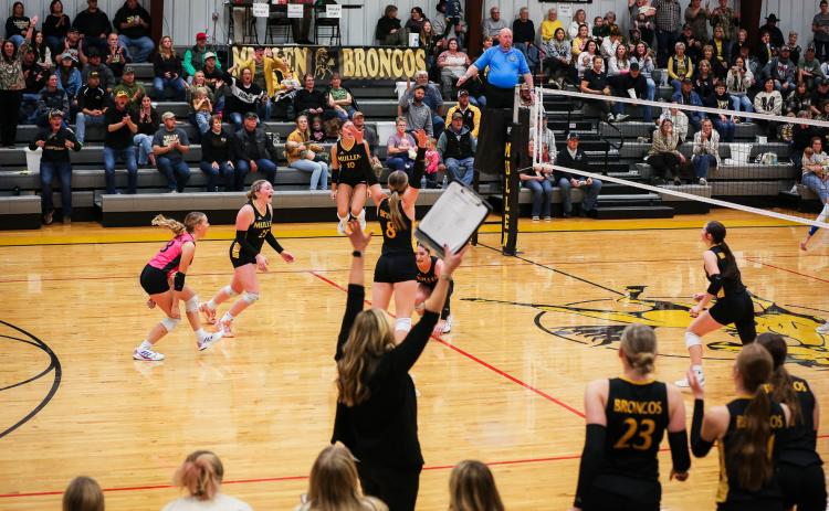 The Lady Broncos on the floor, Head Coach Nichole Ourada and the players on the bench and Mullen fans celebrate as the Broncos clinched their trip to State Volleyball last Saturday afternoon in Mullen. Megan Andersen