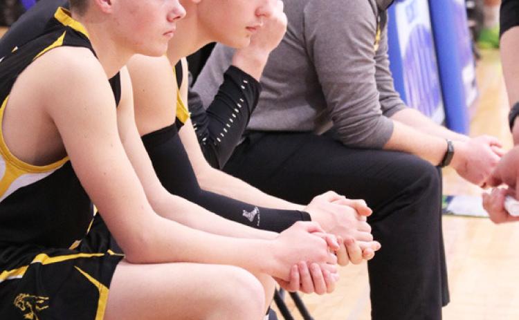 L-r: Cian Connealy, Hunter Brown, Coach Brad Wright (hidden) and Coach Dan Young intent on the subdistrict action. Carolee Brown