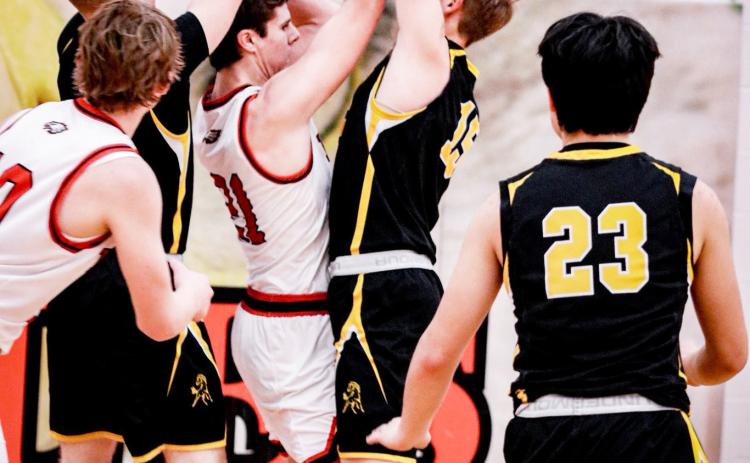 Brandon Hardin (left) and Jackson Vinton trap a Brady player. Carolee Brown Photography