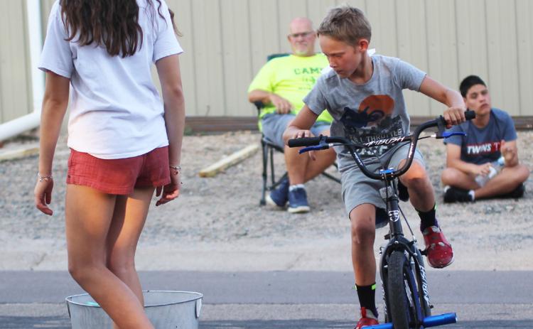 Eli Barnes competing in the sponge drop at the Bicycle Rodeo. Gerri Peterson