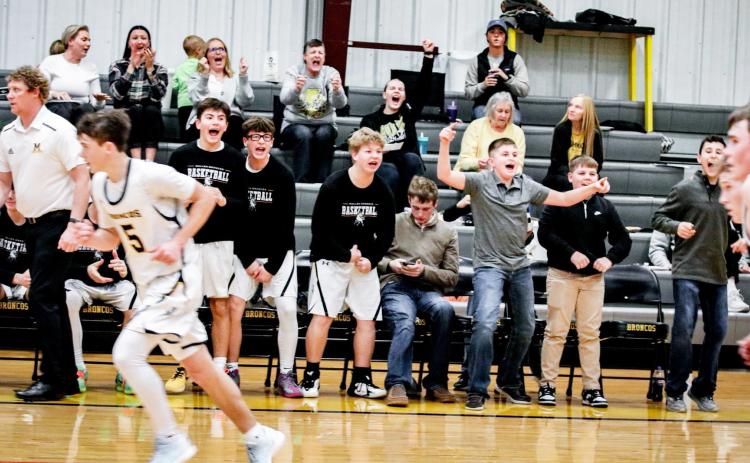 The crowd and bench cheer during the Broncos’ third quarter run against Twin Loup last Tuesday. Carolee Brown Photography