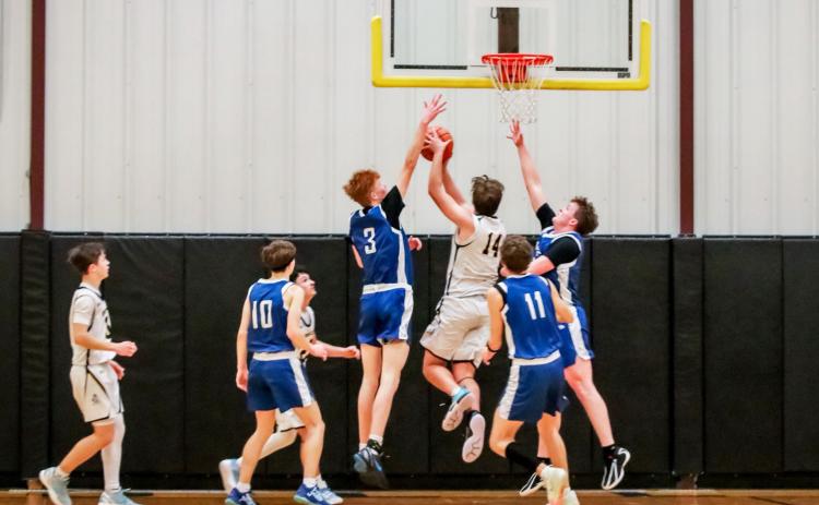 Jacob Walker makes a move to the basket between Hershey defenders last Friday night. Carolee Brown Photography