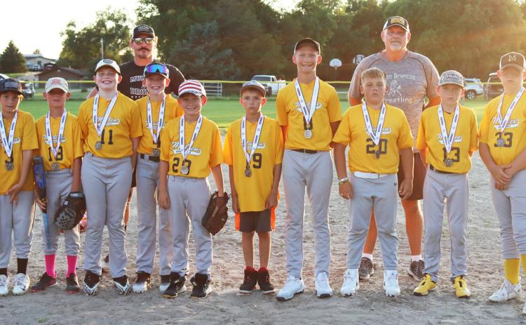The Mullen youth baseball team finished their season as league runners-up last Thursday, June 26 in Mullen, losing in an exciting game against Arnold, 2-3. Pictured l-r: Marcus Lattin, Tuff Pettit, Eli Barnes, Jackson Newman, Coach Bo Pettit, Duke Miller, Cooper Phillips, Jaxyn Evans, Teal Peterson, Carson Hegland, Coach Russ Monette, Kyler Marsh, Collin Donohoe, Zach Hicks. Gerri Peterson