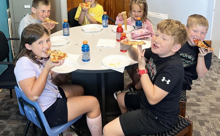 Pictured clockwise around the table from bottom left: Zandra Hebbert, Luke Cox, Nora Pohot, Stevie Johnson, Finnegan Connealy, Harrison Vinton. Brett Mauler