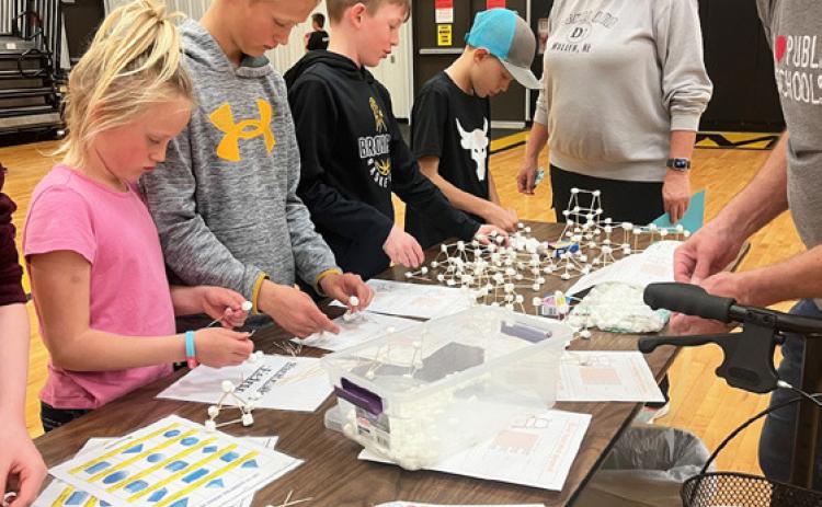 Danielle Peterson, Teal Peterson, Duke Miller and Kyler Marsh try their hand at Marshmallowhedron with Mr. Taylor