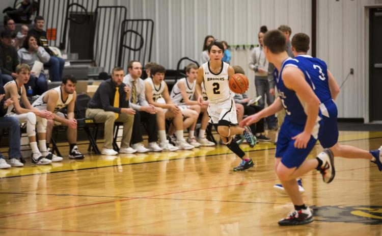 Trevor Kuncl moves the ball up the court last Saturday at the Hilltop Gym against Wallace. Megan Andersen