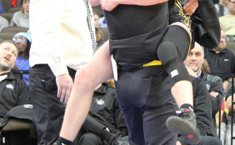 Chase Gracey celebrates his gold medal at State Wrestling with Assistant Coach Bo Pettit as Head Coach Russ Monette looks on. Kris Forsen
