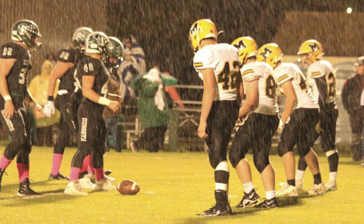 The Broncos get ready for defense at Dunning in the rain last Thursday night. Carolee Brown