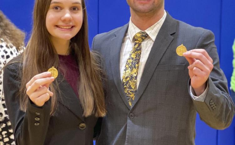 State Speech qualifiers Ashlyn Simonson and Samuel Coble display their District Champion medals last Thursday. Megan Andersen