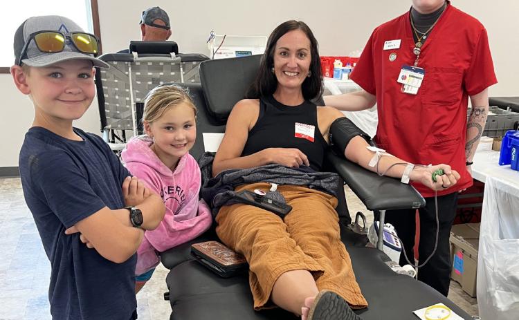 Red Cross staff member Zeke and Tawnee Jewell taught Tawn’s children Tripp and Brogan about blood donation as Tawn donated her 2nd gallon. Nicole Hoffmann