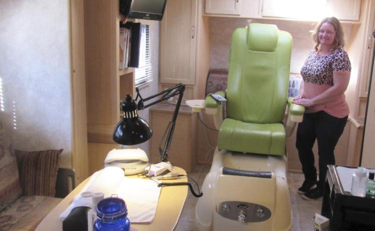 Barbie Neal stands in her mobile unit for Tips &amp; Toes. Marcia Hora