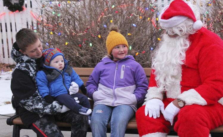 Hayden, Mason and Tatum Deibler. Mason was woke up from a nap for his first visit to Santa, but then didn’t even seem to notice Santa and just had eyes for mom!