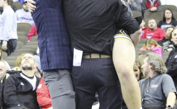 MHS senior Isaac Welch celebrates his gold medal win with Head Coach Russ Monette (left) and Assistant Coach Bo Pettit.