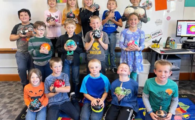 Second graders paint pumpkins
