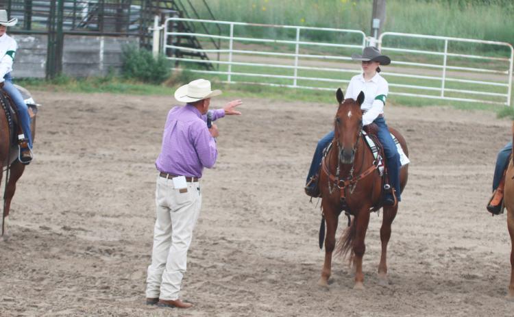 The 4-H Horse judge talks to the intermediate class and crowd about what he was looking for as he judged, l-r: Kendall Phipps, Audrabell Werth, Brandt Mundorf. Gerri Peterson